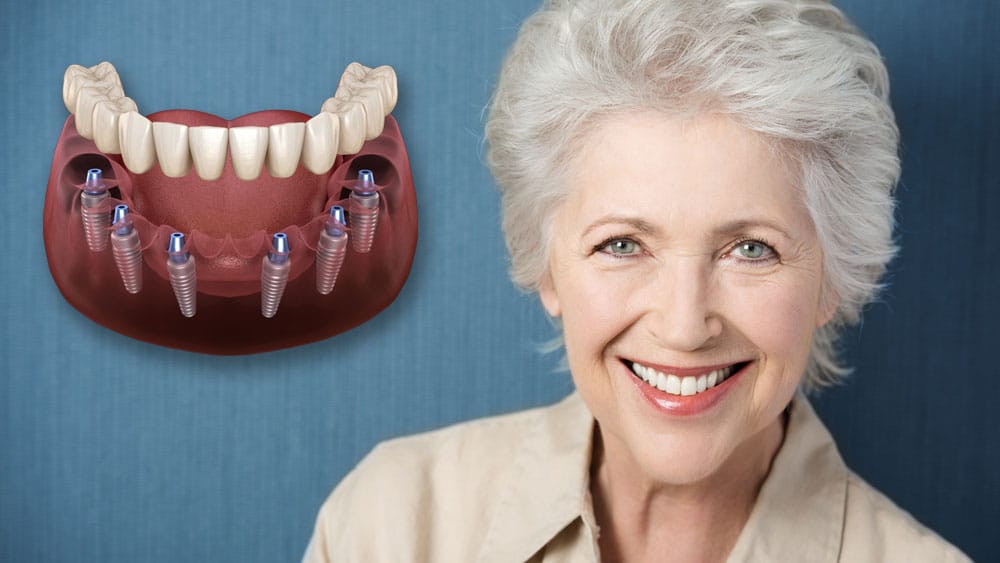 a woman smiling next to a model of teeth